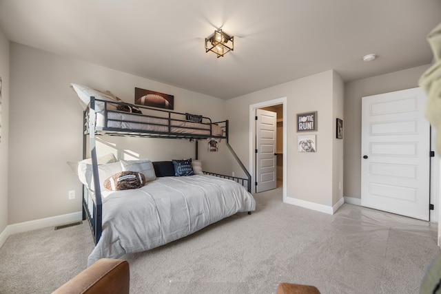 bedroom with light carpet and baseboards