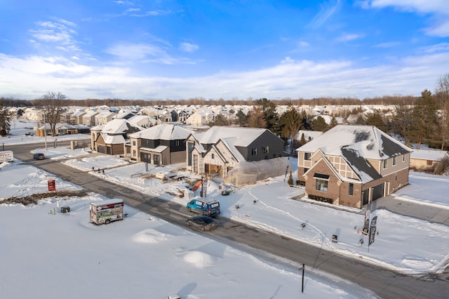 snowy aerial view with a residential view