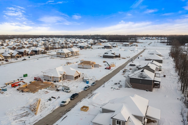 snowy aerial view with a residential view