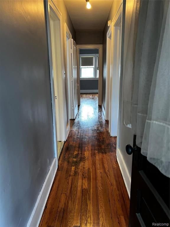 corridor with dark wood-type flooring