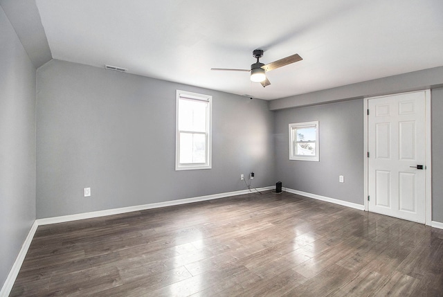 empty room featuring dark hardwood / wood-style flooring, plenty of natural light, and ceiling fan