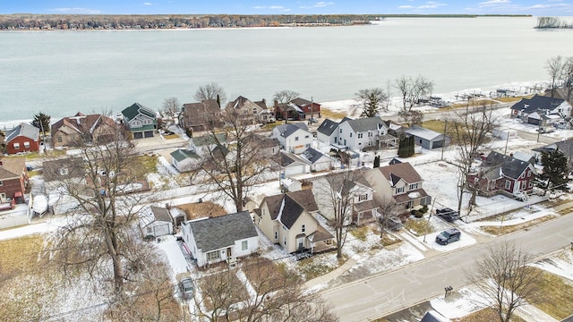 snowy aerial view with a water view