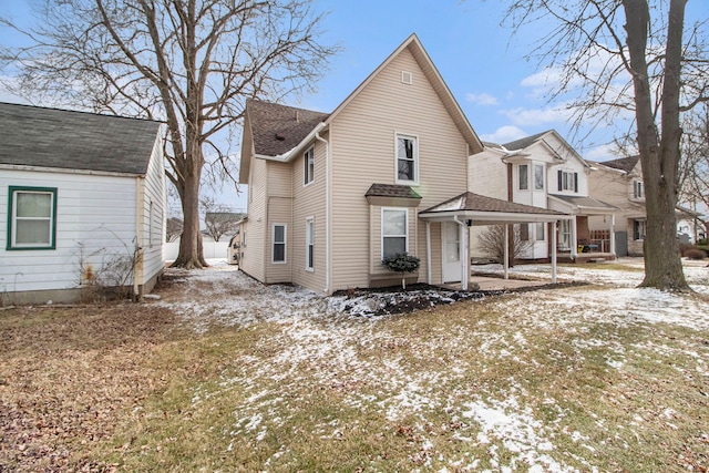 view of snow covered back of property