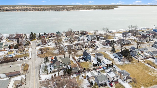 snowy aerial view featuring a water view