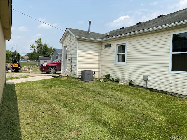 58785 Chennault Dr, New Haven, MI 48048 - view of property exterior featuring a central AC unit and a lawn