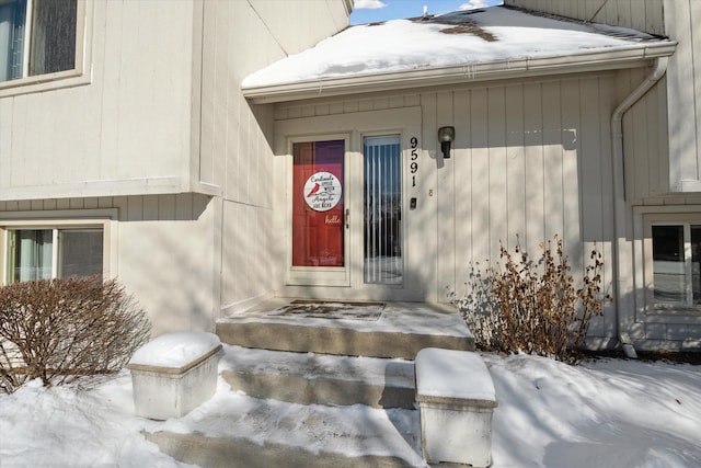 view of snow covered property entrance