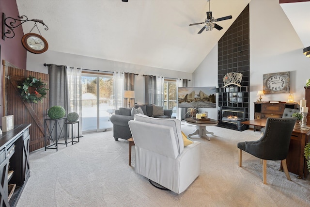 living room with a fireplace, high vaulted ceiling, light colored carpet, and ceiling fan