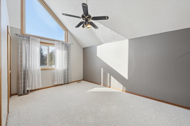 bonus room with a textured ceiling, lofted ceiling, carpet, and ceiling fan