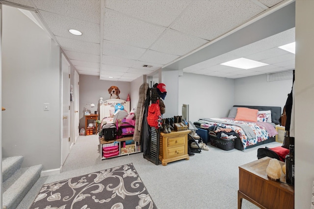 carpeted bedroom featuring a paneled ceiling