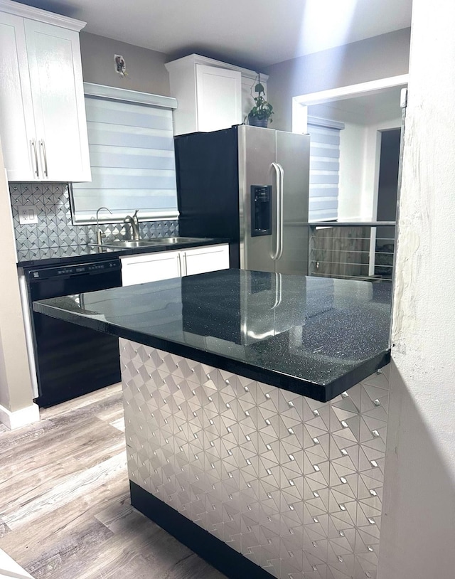 kitchen featuring stainless steel refrigerator with ice dispenser, white cabinetry, black dishwasher, and tasteful backsplash