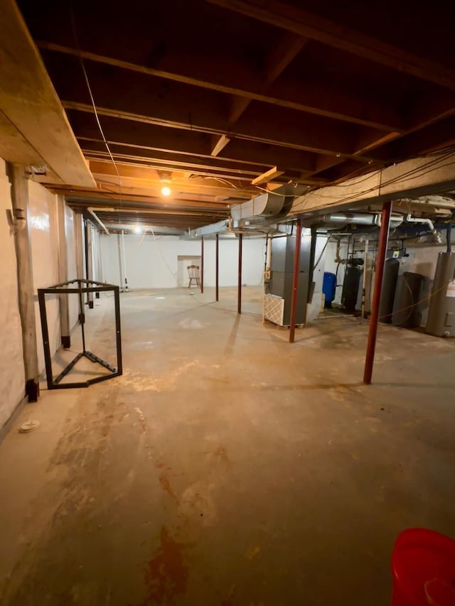 basement featuring heating unit and gas water heater