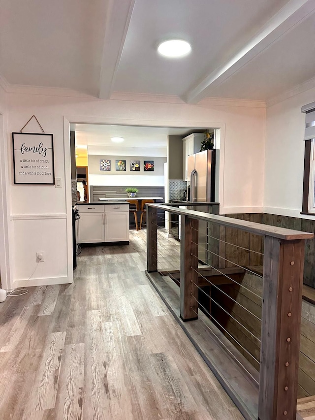 kitchen with white cabinetry, light hardwood / wood-style flooring, beamed ceiling, and stainless steel refrigerator with ice dispenser