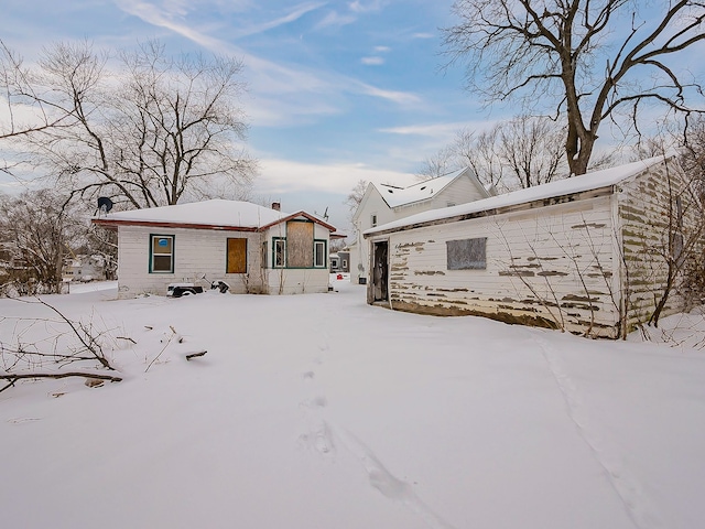 view of snow covered rear of property