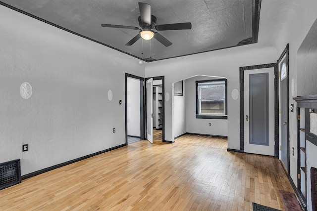 unfurnished bedroom featuring ceiling fan, light hardwood / wood-style floors, and a textured ceiling