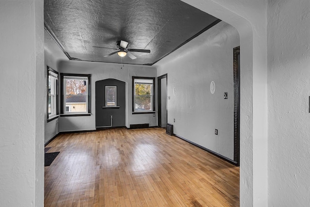 spare room featuring a textured ceiling, light hardwood / wood-style floors, and ceiling fan