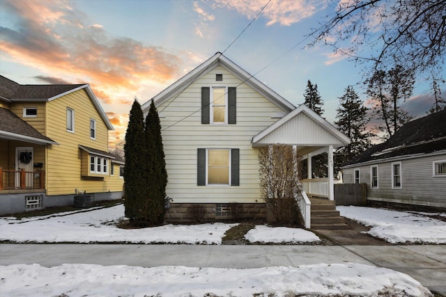 view of front of house with a porch and central AC