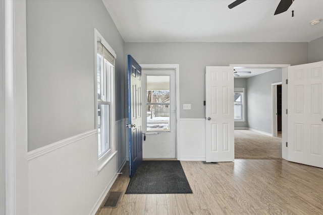 entryway with ceiling fan and light hardwood / wood-style flooring