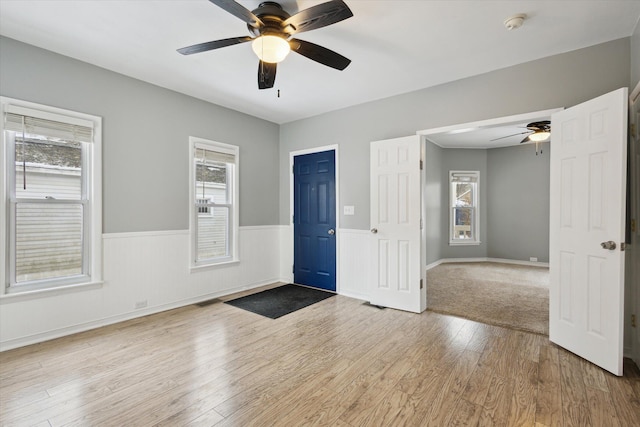 foyer entrance with hardwood / wood-style flooring and ceiling fan