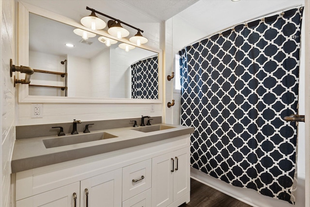 bathroom with vanity and hardwood / wood-style floors