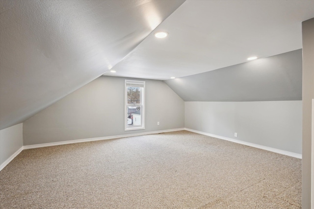 bonus room featuring vaulted ceiling and carpet floors