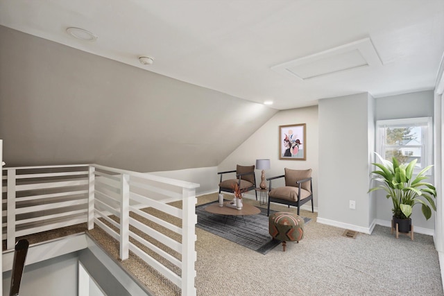 living area featuring vaulted ceiling and carpet floors