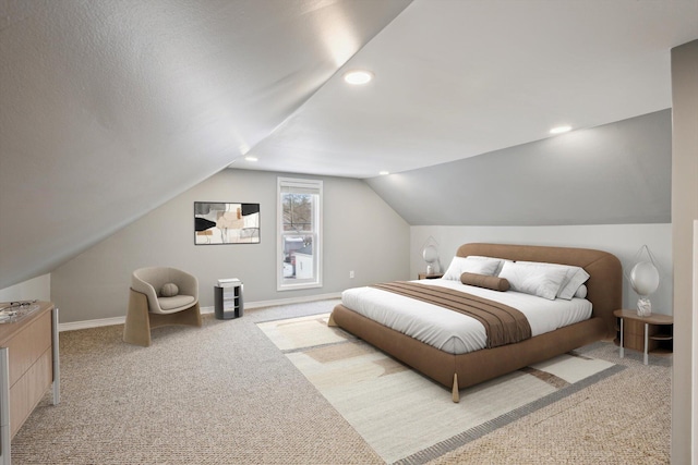 carpeted bedroom with lofted ceiling