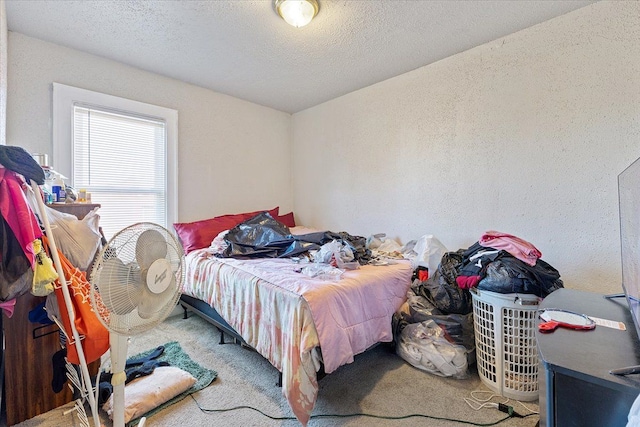 bedroom featuring carpet flooring and a textured ceiling