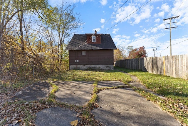 view of property exterior with a yard and a patio area