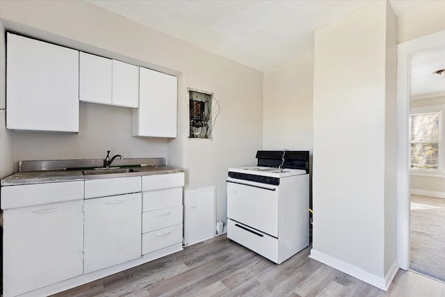 kitchen featuring white cabinets, sink, light hardwood / wood-style flooring, and electric range