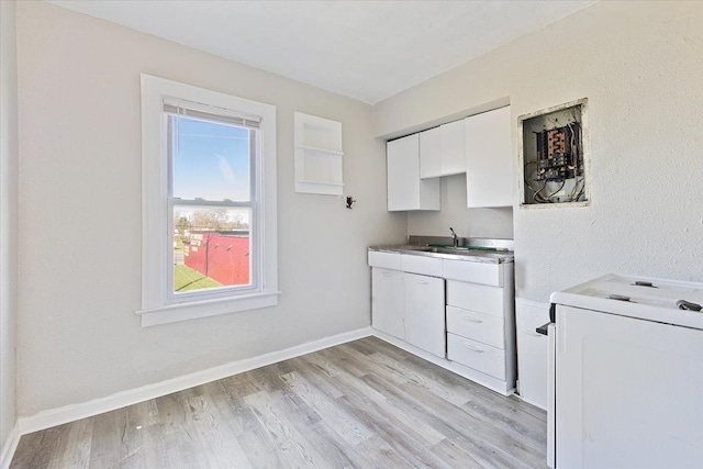 washroom featuring sink, washer / dryer, and light hardwood / wood-style flooring