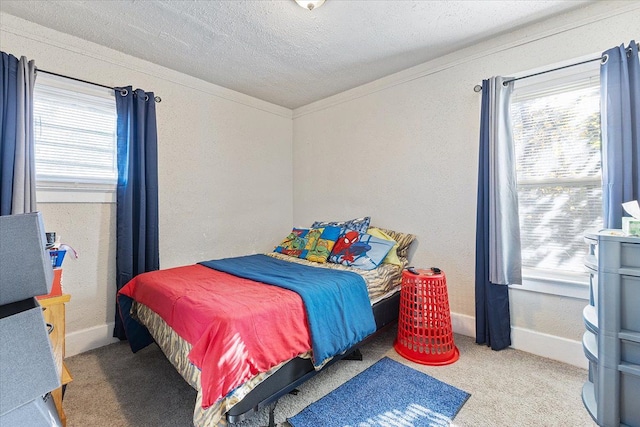 carpeted bedroom with crown molding and a textured ceiling