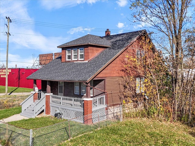 view of front of property with a porch and a front yard