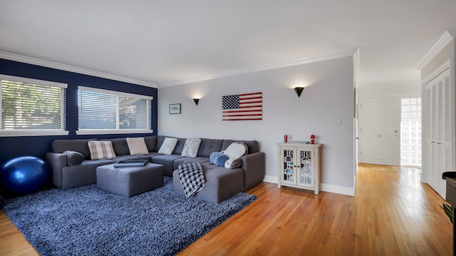 living room with hardwood / wood-style flooring, a wealth of natural light, and ornamental molding