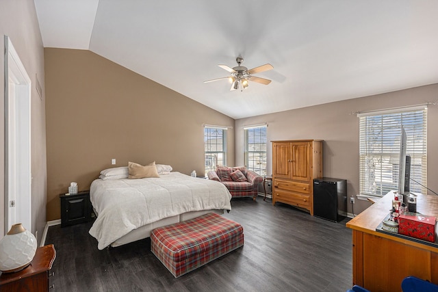 bedroom featuring multiple windows, baseboards, vaulted ceiling, and dark wood-type flooring