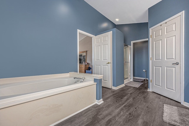 54354 Bryce Canyon Trl, Macomb, MI 48042 - full bathroom featuring baseboards, wood finished floors, a garden tub, and a stall shower