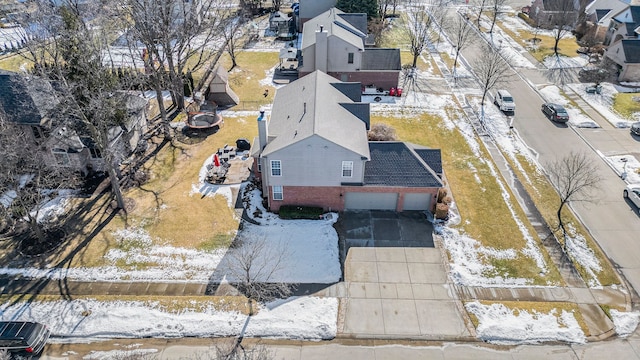 snowy aerial view featuring a residential view