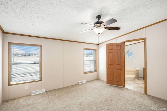5128 Twin Lakes Dr, Kimball, MI 48074 - unfurnished bedroom featuring crown molding, carpet flooring, multiple windows, vaulted ceiling, and a textured ceiling