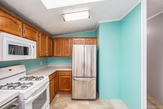 5128 Twin Lakes Dr, Kimball, MI 48074 - kitchen featuring appliances with stainless steel finishes, brown cabinets, lofted ceiling, a textured ceiling, and light countertops