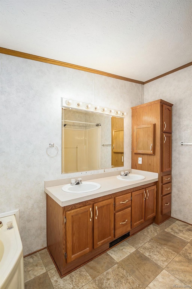 5128 Twin Lakes Dr, Kimball, MI 48074 - full bathroom featuring ornamental molding, double vanity, a tub, a textured ceiling, and stone finish floors