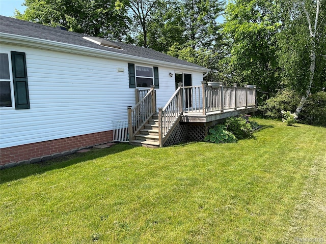 5128 Twin Lakes Dr, Kimball, MI 48074 - back of property with a wooden deck, a lawn, a shingled roof, and crawl space