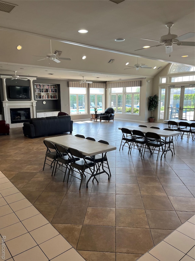 5128 Twin Lakes Dr, Kimball, MI 48074 - dining space featuring a ceiling fan, a glass covered fireplace, tile patterned flooring, recessed lighting, and lofted ceiling