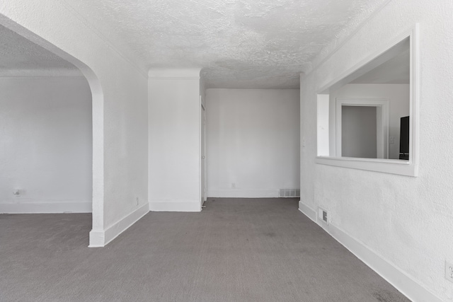 spare room featuring carpet and a textured ceiling