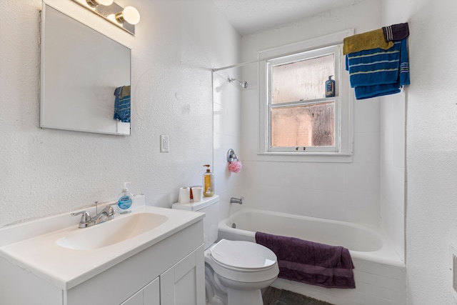 full bathroom featuring vanity, tiled shower / bath combo, and toilet