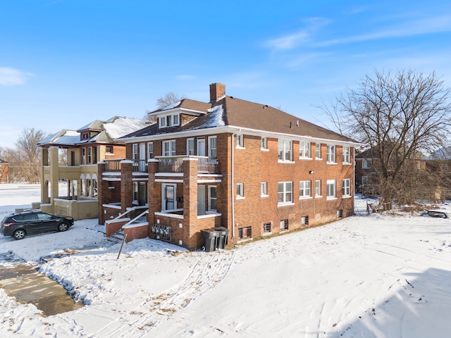 view of snow covered exterior with a balcony