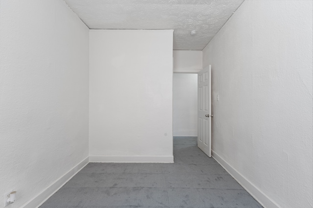 spare room with a textured ceiling