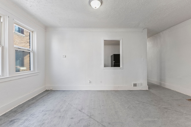 spare room featuring a textured ceiling