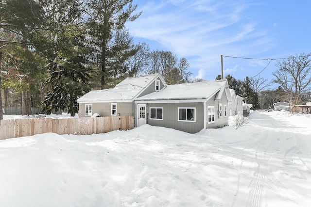 view of snow covered back of property