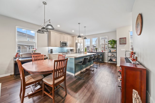 dining area featuring plenty of natural light and dark wood-type flooring