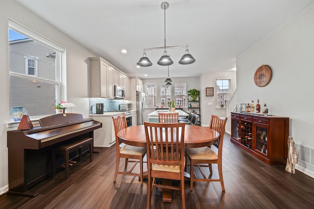 dining space featuring dark hardwood / wood-style flooring