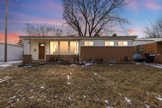 ranch-style house with a lawn